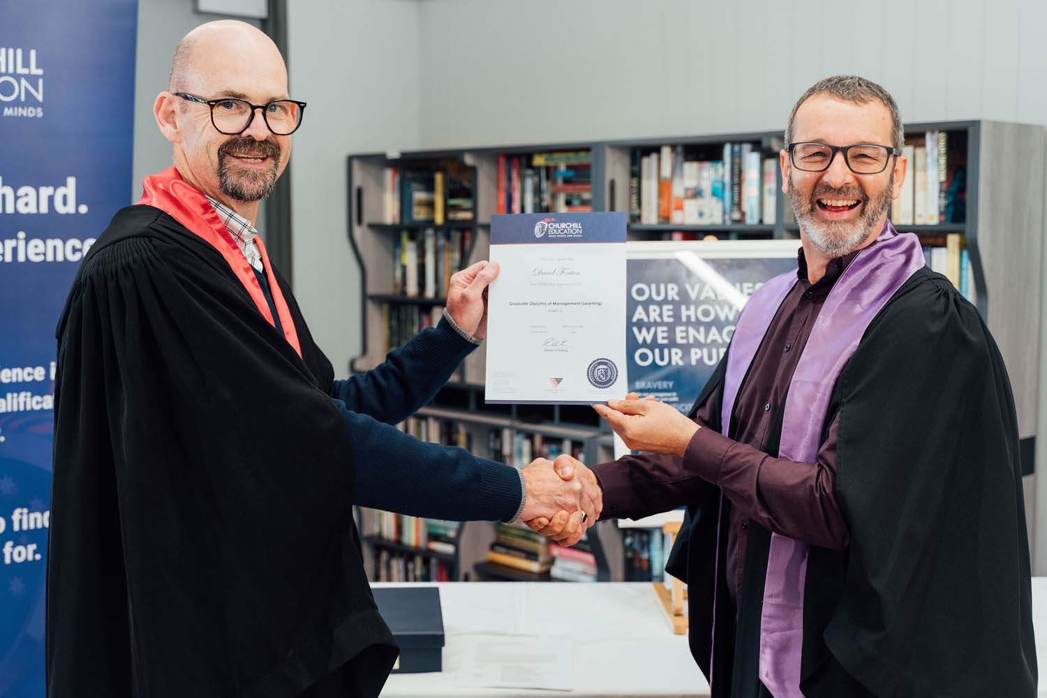 Man receiving qualification in academic robe