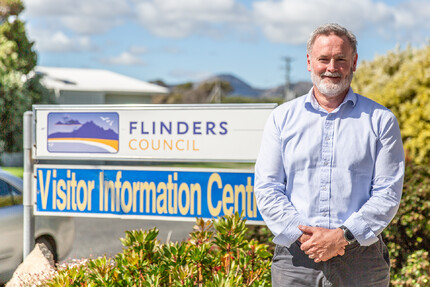 Warren Groves in front of Flinders Council sign